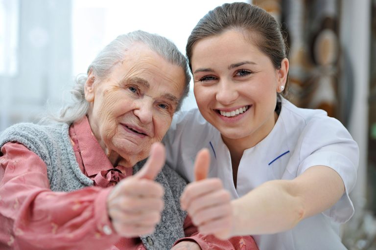 A woman and an old lady giving thumbs up.
